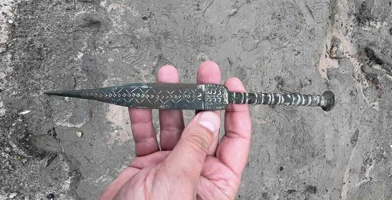 Metal Detectives Unearth Ancient Dagger Decorated with Tiny Stars, Crescent Moons, and Geometric Patterns